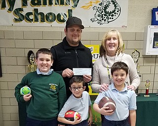 Neighbors | Submitted.HIP Football recently presented a check to Holy Family School. Pictured with the check are, from left, (front) Dominic Payne, Osiron Talbott, Greggory Hann; (back) Coach Dan Talbott and Principal Kathy Stoops.
