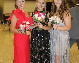 Neighbors | Abby Slanker.Canfield High School seniors, from left, Macey Malinky, Francesca Carney and Mirabella Mangie visited the school’s annual PTO-sponsored Prom Promenade on May 5. Each carried a beautiful array of flowers that coordinated with their dresses.