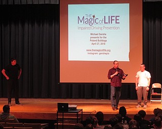 Neighbors | Zack Shively.Poland Seminary High School invited speaker Michael Gershe to the school to talk about the dangers of drinking and driving. Gershe has been affected by drunk driving personally, losing both his mother and best friend. Pictured, he started the presentation on a lighter note, having two students toss beanbags back and forth while wearing impairment goggles.