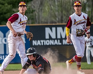 THE VINDICATOR | DIANNA OATRIDGEÊ ÊHowland's Hayden Parker (center) is called out at second base on the front end of a double play attempt and looks to first base with Cardinal Mooney's John Mikos (left) and Ethan Shaw (right) for the call during Division II Sectional Final play at Cene Park on Wednesday. The Cardinals won the game 11-2.