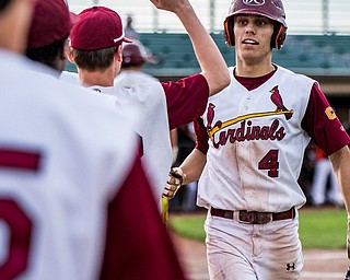 THE VINDICATOR |Ê DIANNA OATRIDGEÊ Cardinal Mooney's John Mikos is congratulated by his teammates after scoring a run during their 11-2 victory over Howland in the Division II Sectional Final at Cene Park on Wednesday.