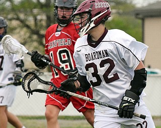 William D. Lewis The Vindicator Boardman's 32) moves the ball  around Canfield's (19) during 5-11-18 action at Boardman..