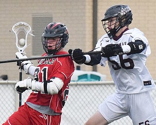 William D. Lewis The Vindicator anfield's (21) moves the ball past Boardman's (56)..