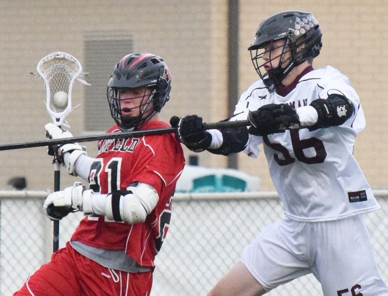 William D. Lewis The Vindicator anfield's (21) moves the ball past Boardman's (56)..