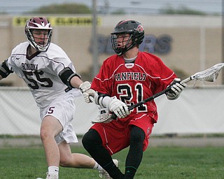 William D. Lewis The VindicatorCanfield's 21 moves the ball past Boardman's 55..