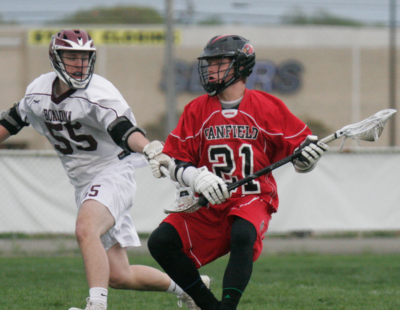 William D. Lewis The VindicatorCanfield's 21 moves the ball past Boardman's 55..