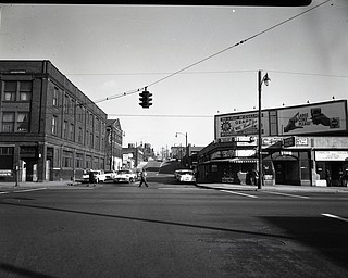 89.119 B1aF323 N. View looking North-East along Watt St. from E. Federal St., Boardman Hotel, Super Poultry- Hot Dogs and Coca Cola sign, St. Cyril's Church and School. 1960. Archives, original negative is 4" x 5" black and white. Digital image is 800 dpi RGB.
