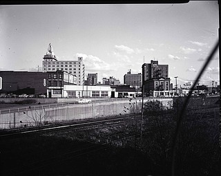 89.119 B1F266 N.   View looking South from the Spring Common Bridge, along Front Street toward Marshall St. Bridge, Valley Hotel, Jolly Bar, Hertz Auto Rental, Home Savings and Loan, Hotel Ohio, Youngstown Hotel; Mural Room, Gulf Oil; 1960. Archives, original negative is 4" x 5" black and white. Digital image is 800 dpi RGB.