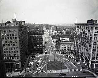 89.119 B1F285 N.  View looking North-East along the Square and Wick Avenue from atop the Mahoning National Bank Building. Left- Dollar Bank, Union Bank, Brown's Drug Store. Right- People's Bank, Palace Theatre, Household Finance Corp., Palace Grill, Palace Hotel, First Presbyterian Church, Masonic Temple.June 3, 1961. Archives, original negative is 4" x 5" black and white. Digital image is 800 dpi RGB.