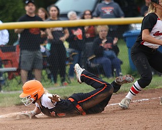 Makenzy Capouellez (4) of Springfield slides safely into third base beating the tag by Girard's Lorren Alejars (5) during Monday evenings semi-finals matchup at South Range High School.  Dustin Livesay  |  The Vindicator  5/14/18  South Range High School, Canfield.