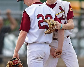 STRUTHERS, OHIO - MAY 15, 2018: Mooney's JT Ogden, left, gets a pat on the back from Jordan Sheehan after being relieved in the fifth inning of their OHSAA tournament game on Tuesday afternoon at Cene Park. Canfield won 4-3. DAVID DERMER | THE VINDICATOR