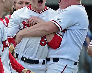 STRUTHERS, OHIO - MAY 15, 2018: Niles' David Mays, right, picks up starting pitcher Marco Defalco after Niles defeated Poland 4-3 to advance int he OHSAA baseball tournament. DAVID DERMER | THE VINDICATOR