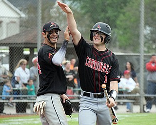 William D. Lewis The Vindincator Canfield's Anthony Longo(1) gets congrats from Alex Hernandez(34) after scoring during win over Niles 5-17-18.