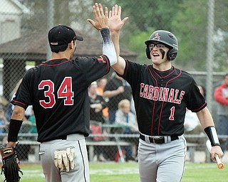 William D. Lewis The Vindincator Canfield's Anthony Longo(1) gets congrats from Alex Hernandez(34) after scoring during win over Niles 5-17-18.