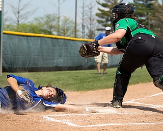 ALLIANCE, OHIO - MAY 17, 2018, Softball Poland Bulldogs vs West Branch Warriors: Poland's Sarah Bo-Cherry (12) eludes the tag of West Branch'sSam Morris (25)  scoring Poland's second run during the 1st inning at Alliance High School.  MICHAEL G. TAYLOR | THE VINDICATOR