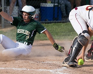 ALLIANCE, OHIO - MAY 17, 2018, Ursuline Irish vs Mooney Cardinals: Ursuline's Macy Ross (2) scores as Mooney's Conchetta Rinaldi (26) fields the ball during the 3rd inning at Alliance High School.  MICHAEL G. TAYLOR | THE VINDICATOR