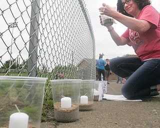 William D. Lewis The vindicator  Christy Kimble, a Boardman Relay For Life volunteer places luminaria on hte track before the annual event got underway Friday 5-18-18.