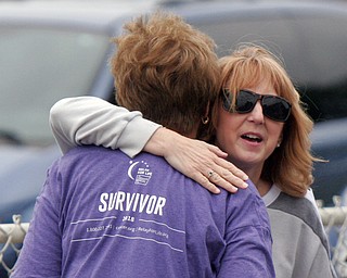 William D. Lewis The Vindicator  Cancer survivor Patty O'Shaughnessey of Poland (back to camera) gets a hug from Kathy McKee of Canfield during Boardman Relay for Life 5-18-18.