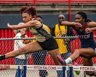 DIANNA OATRIDGE | THE VINDICATOR Warren G. Harding's Faith Burch (left) and Austintown Fitch's Khala Cameron (right) compete in the Girls 100 Meter Hurdles at the Division I District Track and Field Championship in Austintown on Friday. They finished fourth and third, respectively, advancing to the Regional semi-finals.