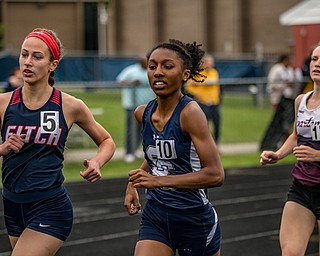 DIANNA OATRIDGE | THE VINDICATOR Austintown Fitch's Lauren Dolak (left), Solon's Olivia Howell (center), and Boardman's Casey Zaitzew (right) compete in the Girls 1600 Meter Run at the Division I District Track and Field Championship in Austintown on Friday.