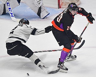 YOUNGSTOWN, OHIO - MAY18, 2018: Phantoms' Curtis Hall sakes with the puck while being check by Fargo's Robbie Stucker during Friday nights Clark Club Final game at the Covelli Centre. DAVID DERMER | THE VINDICATOR