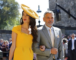 Amal Clooney and George Clooney arrive for the wedding ceremony of Prince Harry and Meghan Markle at St. George's Chapel in Windsor Castle in Windsor, near London, England, Saturday, May 19, 2018. (Gareth Fuller/pool photo via AP)