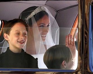 Meghan Markle arrives for the wedding ceremony of Prince Harry and Meghan Markle at St. George's Chapel in Windsor Castle in Windsor, near London, England, Saturday, May 19, 2018. (Chris Radburn/pool photo via AP)