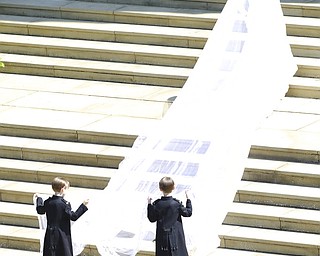 In this photo provided by the MOD Meghan Markle climbs the stair to the St George's Chapel, Windsor Castle, for the wedding ceremony of Prince Harry and Meghan Markle in Windsor near London, Saturday, May 19, 2018. (Owen Cooban/MOD via AP)