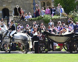 Prince Harry and Meghan Markle leave after their wedding ceremony at St. George's Chapel in Windsor Castle in Windsor, near London, England, Saturday, May 19, 2018. (Ian West/pool photo via AP)