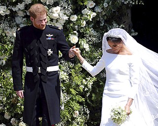 Britain's Prince Harry and Meghan Markle leave after their wedding at St. George's Chapel in Windsor Castle in Windsor, near London, England, Saturday, May 19, 2018. (Andrew Matthews/pool photo via AP)