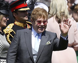 Sir Elton John waves arrives for the wedding ceremony of Prince Harry and Meghan Markle at St. George's Chapel in Windsor Castle in Windsor, near London, England, Saturday, May 19, 2018. (Chris Jackson/pool photo via AP)