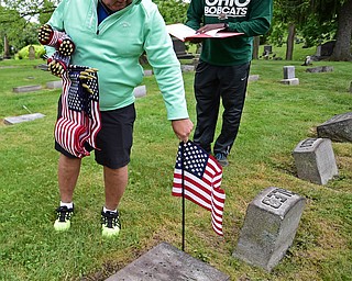 YOUNGSTOWN, OHIO - MAY 19, 2018: John Freeze of Poland places an American flag at the grave of a former servicemen, Saturday morning at the Oak Hill Cemetery. DAVID DERMER | THE VINDICATOR