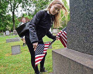 YOUNGSTOWN, OHIO - MAY 19, 2018: Heather Fouts of Youngstown places an American flag at the grave of a former servicemen, Saturday morning at the Oak Hill Cemetery. DAVID DERMER | THE VINDICATOR