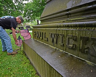 YOUNGSTOWN, OHIO - MAY 19, 2018: Chip Proffit of Youngstown places an American flag near the resting place of Paul Wick, Saturday morning at the Oak Hill Cemetery. DAVID DERMER | THE VINDICATOR