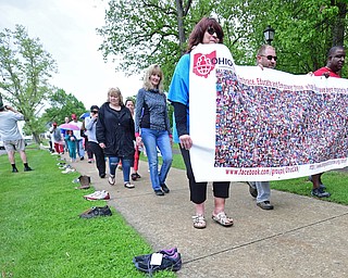 YOUNGSTOWN, OHIO - MAY 19, 2018: Hope Anne Youngstown the Mahoning County Coordinator for Ohio Can, James Garltic of Niles and Youngstown Mayor Jamael Tito Brown walk on the sidewalk in Wick Park earring a poster with the pictures of people who have passes away from opioid overdoses, Saturday afternoon. DAVID DERMER | THE VINDICATOR