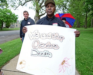 YOUNGSTOWN, OHIO - MAY 19, 2018: Joe Reid of Youngstown carries a poster while walking in Wick Park during the opioid walk, Saturday morning. DAVID DERMER | THE VINDICATOR