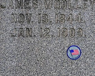 YOUNGSTOWN, OHIO - MAY 19, 2018: The tombstone of James Woolley is marked with a sticker representing him being a US Veteran, Saturday morning at the Oak Hill Cemetery. DAVID DERMER | THE VINDICATOR