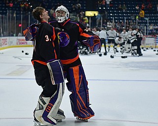 YOUNGSTOWN, OHIO - MAY 19, 2018: Youngstown goalie Ivan Prosvetov, left, is consoled by Wouter Peeters while members of the Fargo Force celebrate winning the league championship behind them, Saturday night at the Covelli Centre. DAVID DERMER | THE VINDICATOR