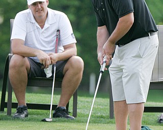 William D. Lewis The Vindicator John elias of Canfield tries putting while blindfolded during GGOV Scramble 5-21-18 at Tippecanoe. Looking on is Brian Cross.