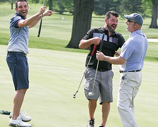 William D. Lewis The Vindicator  Lou Lyras of Poland, right,get congrats from George Rohan of Boardman, left, and Derek Knepper of Canfield after sinking a long putt on #9 at Tippecanoe 5-21-18 in GGOV scramble.