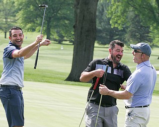 Lou Lyras of Poland, right, gets congrats from George Rohan of Boardman, left, and Derek Knepper of Canfield after sinking a long putt on #9 at Tippecanoe Monday in a Coors Light GGOV scramble qualifier.