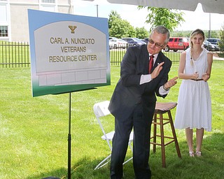 ROBERT K YOSAY  | THE VINDICATOR..Jim Tressel and Candace Campana applaud the unveiling of the sign...dedication ceremony Wednesday in which the Youngstown State University Office of Veterans Affairs, 633 Wick Ave., was renamed the Carl A. Nunziato Veterans Resource Center....-30-