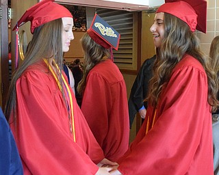 William D Lewis The Vindicator   Niles Valedictorians Gabriella Miller, left, and Halli Petillo share a moment during 5-23-18 commencement at Packard Music Hall in Warren.