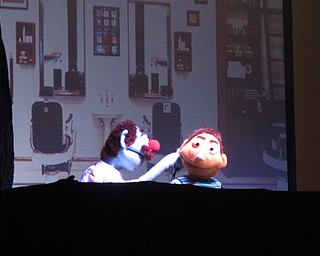 Neighbors | Zack Shively.The Sadecky's Puppets show, "Good Fortune," told the story of Benny, a child who, at the beggining, dis not think much of his interactions with others and often came off as rude and mean. He chenged his actions after reading a fortune cookie, becoming a kind person who helps the others in the show. Pictured, a barber cut Benny's hair, which prompted Benny to tell him how poor of a job he did.