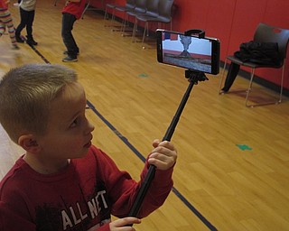 Neighbors | Zack Shively.Google brought their new app for augmented reality to Austintown Elementary School. The app allowed the students to scan images and look at a model of them. Pictured, first grade student Mason Dunlap looked at a model of a volcano.