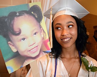 William D. Lewis The Vindicator Harding grad Breasa Morgan holds  fan with a photo of her from kindergarten during 5-24-18 commencement at Packard Music Hall in Warren.