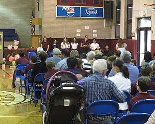 Neighbors | Zack Shively.The guests and students at St. Chales School on VIP Day had five sessions together where they ate in the cafeteria, met the teachers and had a prayer service in the gymnasium. Pictured, members of the school choir sang at the event.
