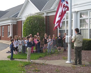 Neighbors | Zack Shively.Poland's scouts in Pack 2 and Troop 2 saw that North Elementary's flag had been tattered and needed replaced. The group came to the school and replaced the flag as a part of their community service. Pictured, David Vuksanovich raised the flag while the others paid respect to the flag.