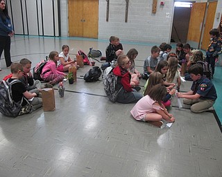 Neighbors | Zack Shively.Amanda McNinch and the scouts taught the students at Poland North Elementary's after school program about the American flag, what the colors on the flag represent, how to dispose of one and how to fold it correctly. Pictured, the students practiced folding a flag using a piece of paper.