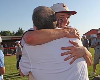 South Range senior Brandon Youngs (27) gets emotional as he hugs his dad Scott Youngs after beating Grand Valley in Friday nights Regional Finals matchup at Massilon High School. Dustin Livesay  |  The Vindicator  5/25/18  Massilon.